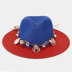 Straw sun hat with shell accents in navy blue and red contrast for beach vacation style