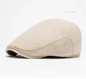 Macro detail of beige herringbone tweed flat cap showing classic wool blend texture