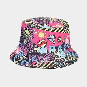 Macro detail of the reversible bucket hat featuring vibrant graffiti prints and cotton twill texture