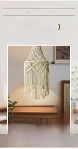 Detail of hand-woven macrame lampshade showing intricate cotton rope tassels and warm texture