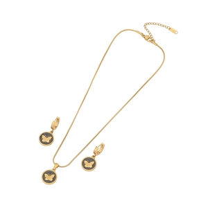 Golden butterfly necklace and earrings set in stainless steel with black textured inlay
