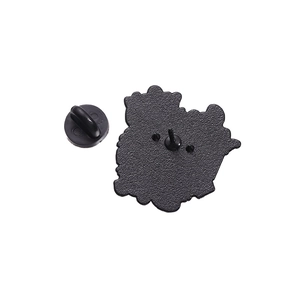 Macro detail of enamel pin back with matte black finish and rubber clutch attachment