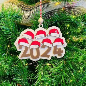 2024 Christmas hat wooden pendant hanging on a festive decorated Xmas tree