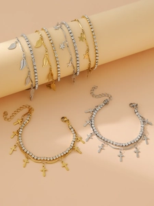 Close-up of double-layered stainless steel bracelets with star, cross, and leaf pendants