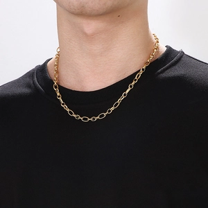 Classic golden titanium steel cable chain necklace worn on a black t-shirt closeup