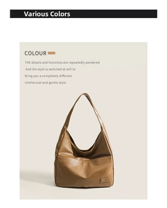 Detail view of the brown leather shoulder bag with a front pocket and logo plaque