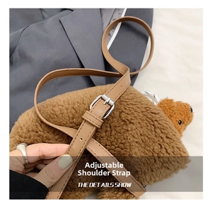 Detail of adjustable khaki leather shoulder strap with metal buckle on fuzzy bear bag