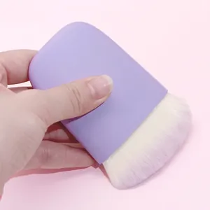 Flat head makeup brush with purple handle and dense white bristles for blush or powder