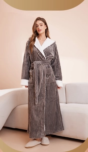 Detail of grey striped flannel bathrobe featuring plush white faux shearling trim and belt