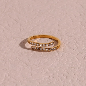 Adjustable gold plated stainless steel crisscross ring with transparent zircon stones