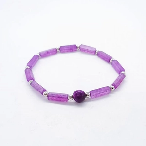 Detailed shot of purple amethyst rectangle bead bracelet with silver spacers on white