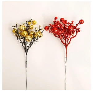 Detail of red and gold Christmas glitter berry stems with shimmering finish for festive decor