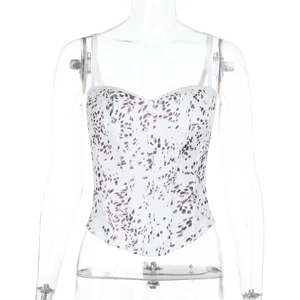 Detail of white corset top with brown and blue print, thin straps and boning structure