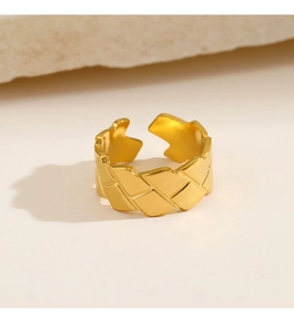 Detailed view of 18k gold plated stainless steel ring with quilted pattern on stone background