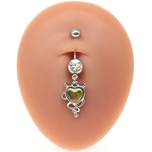Close-up of devil heart navel ring with green gemstone and white crystal on skin model