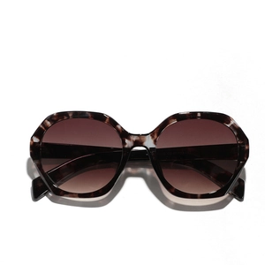 Vintage oversized tortoiseshell sunglasses with brown gradient lenses in a flat lay view