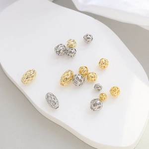 Close-up of gold and silver hollow metal spacer beads for DIY jewelry making