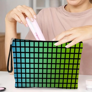Blue-green gradient checkered cosmetic bag with wrist strap shown in use for storage