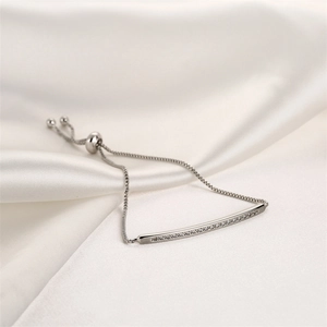 Detail of silver bar bracelet with cubic zirconia on silk fabric with adjustable slider