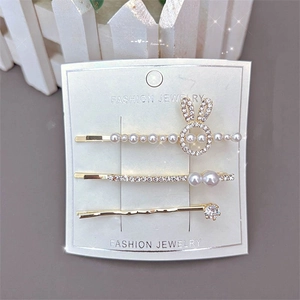 Three-piece gold hair clip set with sparkling rhinestones, pearls, and rabbit charms