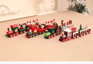 Detail shot of four colorful wooden Christmas trains with snowmen and gift decorations