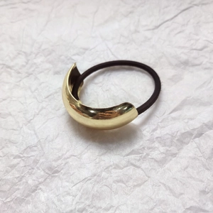 Minimalist gold metal alloy curved ponytail holder with elastic black hair tie for women