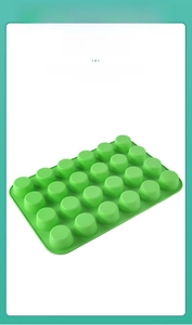 Detail view of 24-cavity green silicone mold for muffins, chocolate and baking