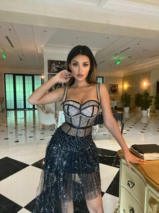 Close-up of sexy black mesh bodycon dress with sequin details and halter neck style