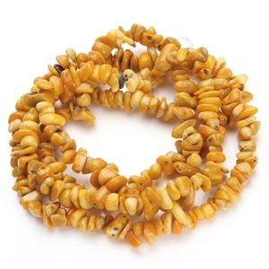 Close-up of natural yellow shell gravel beads strand for DIY jewelry making accessories