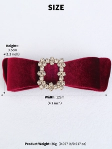 Macro shot of large red velvet bow hair clip with crystal rhinestone center detail