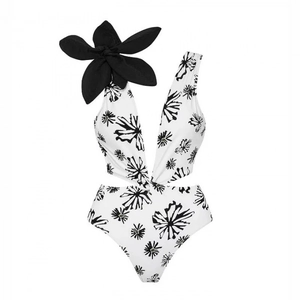One-piece swimsuit in black and white floral print with a 3D flower and waist cut-outs