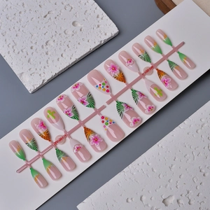 Close-up of pink 3D floral almond press-on nails with leopard patterns and gold accents