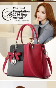 Detail of color-block tote bag with red bow charm and gold pendant detail
