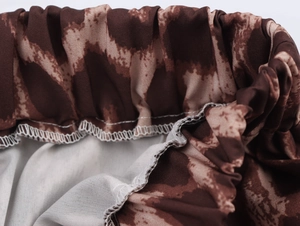 Detail view of elastic waistband with stitching and leopard print fabric texture