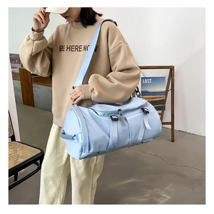 Detailed view of light blue nylon sports duffel bag with adjustable shoulder strap
