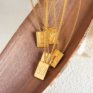 Golden titanium steel square alphabet pendant necklaces featuring embossed letters L M W D