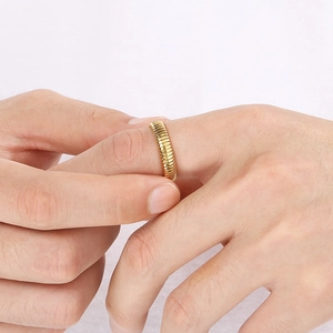 Detailed close-up of a gold geometric Tubogas ring on a finger with a minimalist style