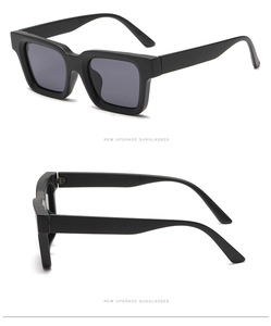 Detail view of bold black square frame sunglasses with a thick retro texture design
