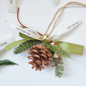 Nordic pine cone ornament with green ribbon and gold bell for Christmas decor