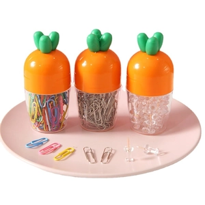 Carrot shaped office stationery set with paper clips and push pins in clear jars