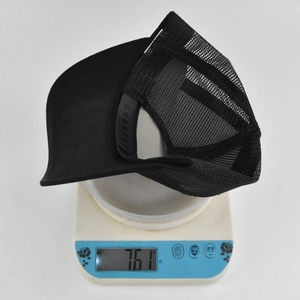 Detail showing the lightweight design of this black trucker hat weighing only 76.1 grams
