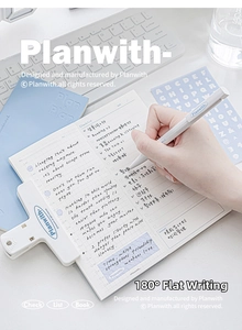 Detailed set showing daily planner, matching pen and binder clip on an office desk