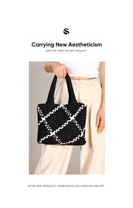 Detailed shot of woven tote bag with black and white checkered pattern and woven handle