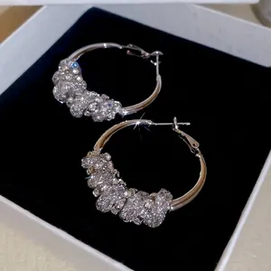 Sparkling silver round hoop earrings with crystals in a luxury white jewelry box
