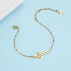 Elegant gold hollow cross bracelet with lobster clasp and adjustable extension chain