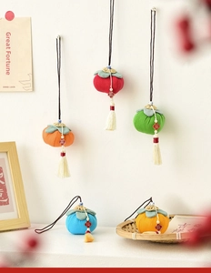 Detailed view of colorful fabric persimmon charms with tassels and lucky tags