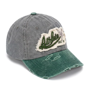 Detail of distressed brim and athlete patch embroidery on a vintage baseball cap