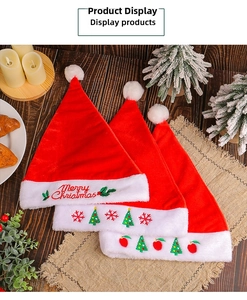 Detailed close-up of velvet Christmas hats with embroidery and plush trim on rustic fabric