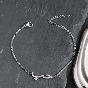 Detailed view of silver Arabic script bracelet with pink zircons and adjustable clasp