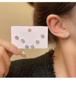 Detail shot of three pairs of 925 silver stud earrings with cubic zirconia in geometric shapes